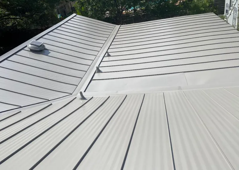 Solar attic fan installed on a metal roof for Roof Ventilation in Pleasantville
